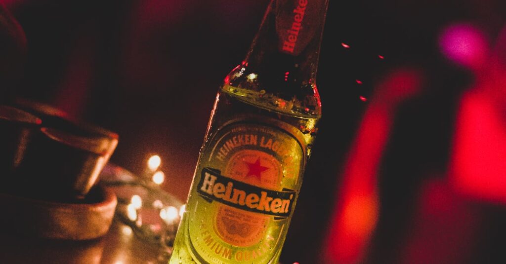 Close-up of a Heineken beer bottle illuminated by string lights in a vibrant party setting.